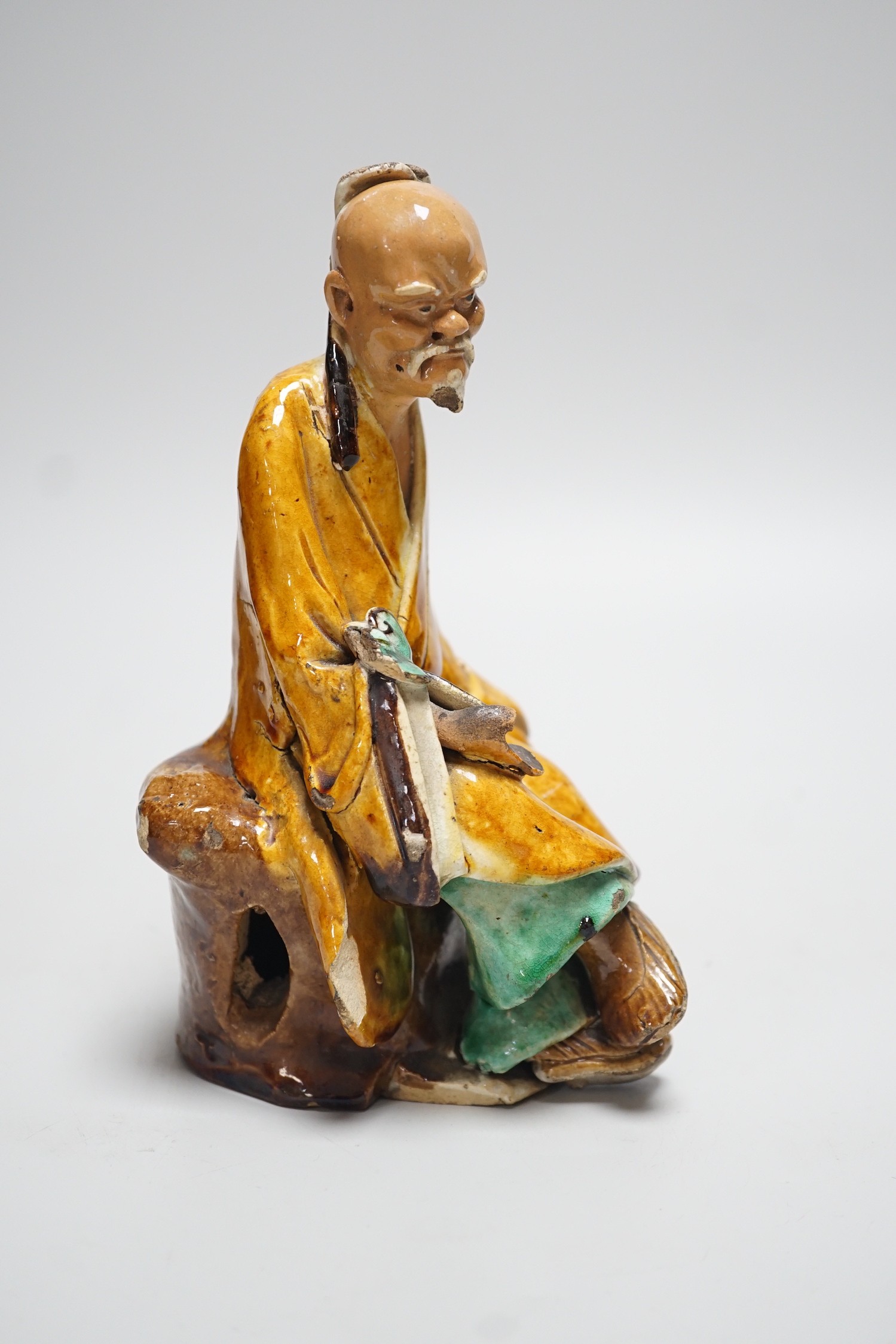 A Chinese Shiwan figure of a sage, possibly 18th century, 19cms high